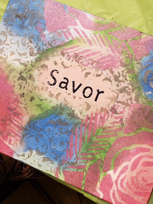 A placemat featuring the word "savor" prominently displayed in an elegant font.